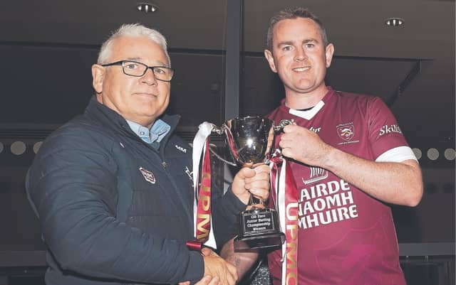 Mick Mullen, Chairman Co. Board presents the UPMC JHC Cup to Leixlip captain John Buckley, Photo by Sean Brilly