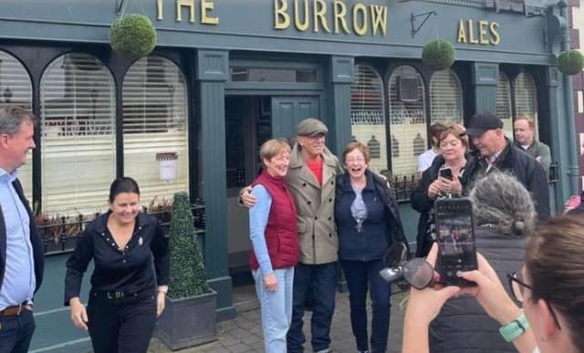Bruce Springsteen taking photographs with locals outside The Burrow pub in Rathangan last year (File image).
