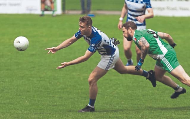 Sean Cullen, Naas, lays off his hand pass as Sarsfields Fergal Durkan gives chase in the Hanlon Concrete SFL Division 1 (Leinster Leader Cup) final at Manguard Park, on Sunday. Photo: Sean Brilly