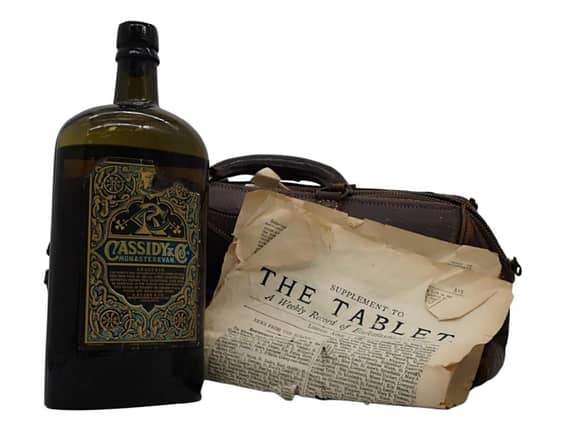 The bottle of whiskey, the newspaper and the doctor's bag / PHOTO: whiskeybidder.com
