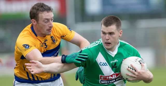Sarsfields Shane Doyle holds off the challenge of Raheens Tom Early