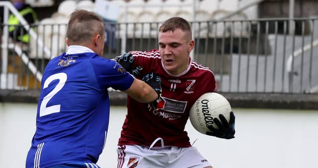 Caragh Kevin Campbell holds off the challenge of Robertstown Cole Lyons during the 2020 Tom Cross Junior Football Championship Final. Picture: Sean Brilly