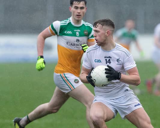 Shane O'Sullivan spins clear from the in rushing Bill Carroll of Offaly during the Leinster U20 Football Championship game played at St Conleths Park, Newbridge