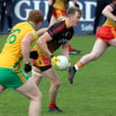 St Laurences midfielder Mark Glynn being pursued by Michael McLoughlin of Two Mile House in the 2025 National Electrical Wholesalers Intermediate Football Championship
