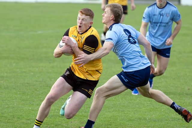 Caelum Flanagan of Clogherinkoe tries to break through the tackle of Eadestown midfielder Rian Boran