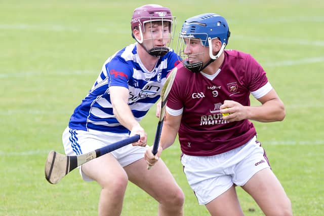 Leixlip midfielder Eoghan Harrington shakes off the challenge from Sean MacDonncha of Naas in the 2026 Kildare IHC