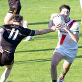Milltown wing-back Hugh Hamilton side steps the challenge of Brian McGrath of Ballyteague in the 2026 Kildare IFC