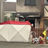 Floral tributes outside the scene of the house fire