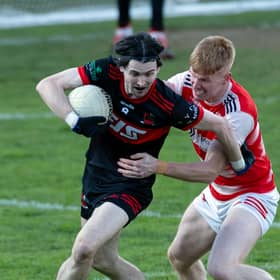 St Kevin's midfielder Jamie Smyth pushes his way clear from the challenge of David Lovely of Cappagh