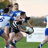 Ciaran O'Brien of Kilcullen gets his shot off under pressure from Straffan defenders