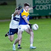 Carbury sharpshooter Eoin Cully lines up his shot at the Allenwood posts with Callum O'Reilly in pursuit