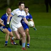 Athgarvan full-forward Jordan Nolan Mullally turns away from Robertstown duo Danny Scully and Anthony Moran