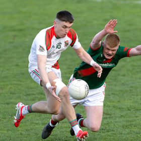 Suncroft forward Eoghan Lawless solo's his way past Kevin Byrne of Milltown attempting to block in the 2026 IFC final