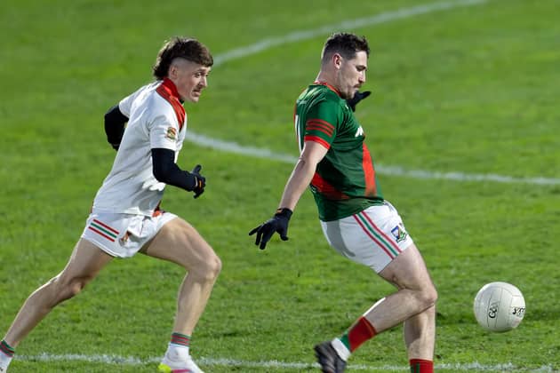 Milltown Alan Dignam openings the scoring of the Intermediate Football Championship 2026 with a point from play after he goes past Suncroft Chris Philips