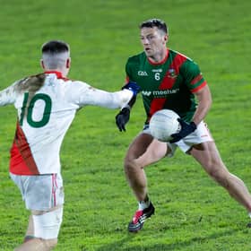Milltown goal-scorer Colin O'Shea weighs up his options as Eoghan Lawless of Suncroft attempts to close him down