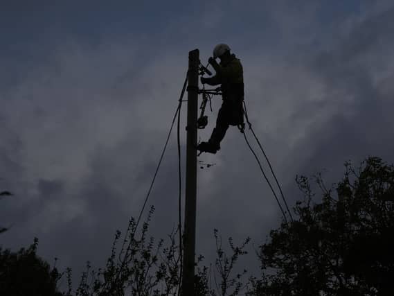 A network technician on a power pole