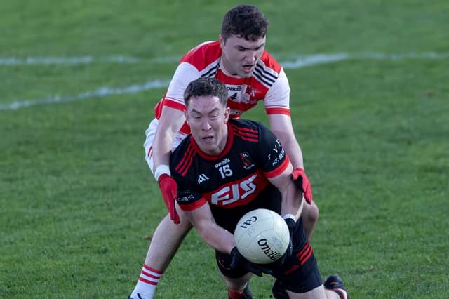 St Kevin's corner-forward Barry Noone under pressure from Oisin O'Cuill of Cappagh in the 2026 Tom Cross JFC final