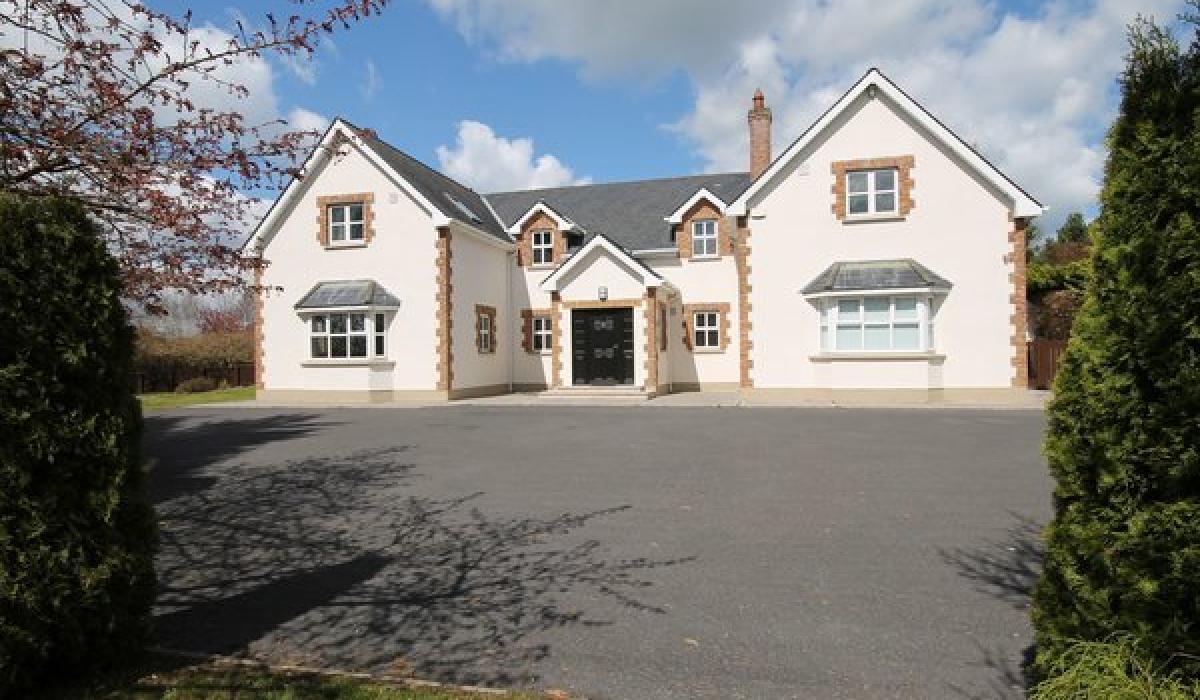 This regal home in Two Mile House boasts a sunroom, detached garage and 2 water features for €