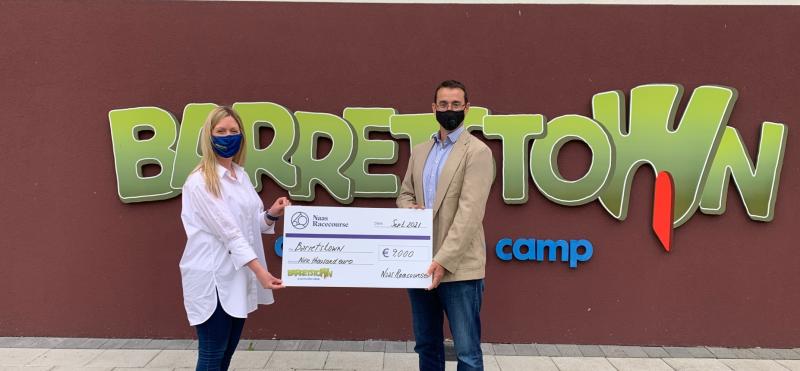  Eamonn McEvoy, General Manager of Naas Racecourse pictured with Caroline Tobin,  Corporate Account Manager of Barretstown with a €9,000 cheque for Barretstown Children