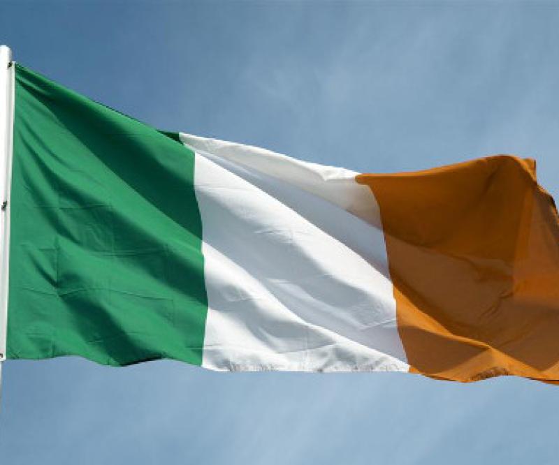 Irish flag over a blue sky background