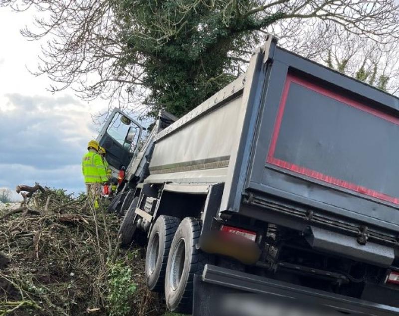 PHOTOS: Truck driver trapped in cab after skidding on ice and hitting tree 