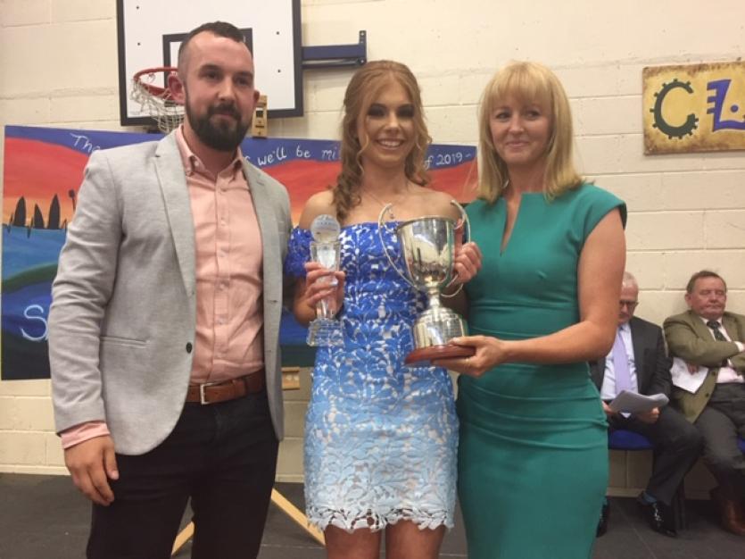 Ciara Moran is pictured receiving the Ray O'Malley Cup for Outstanding Sportsperson of the Year by Ms. Bradshaw and Mr. Malone from the PE Department.