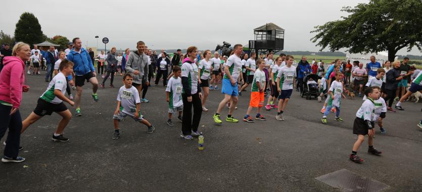 Brendan Loughlin from Brendans Running Club warms up the crowd