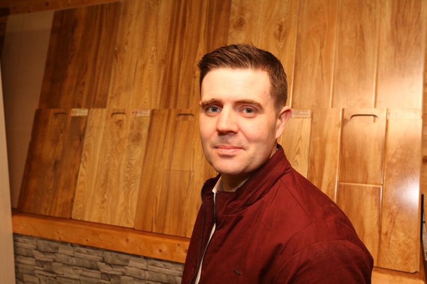 Paudie Mackin with a TCS Carpet and Flooring display at Fordes Superstore.