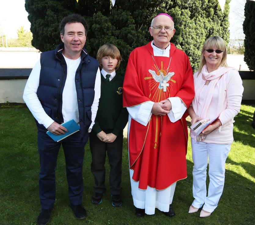 Bishop Eamon Walsh with Tom, Tom Jr and Jackie Healy