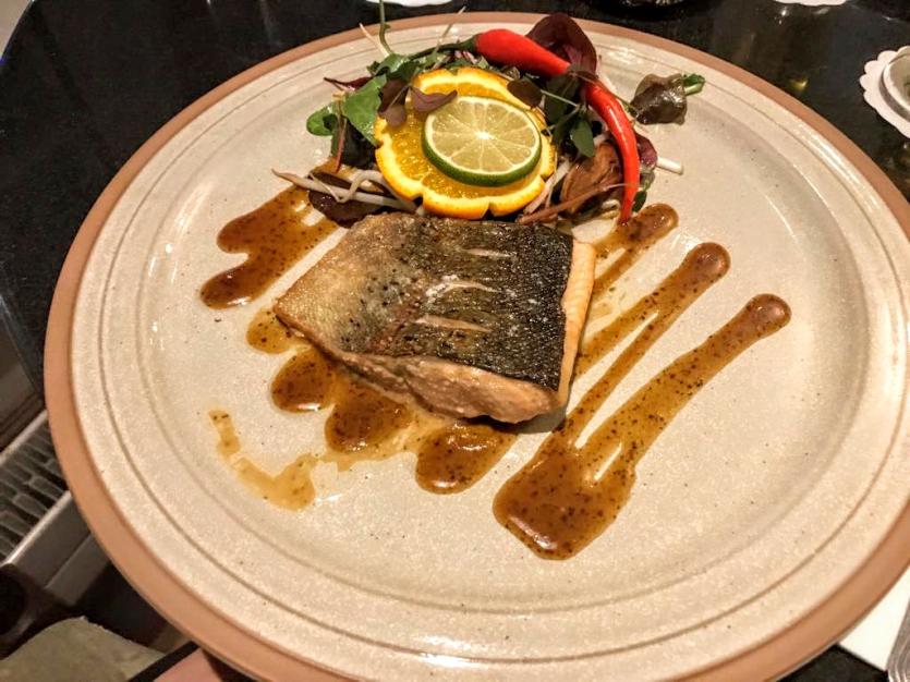 Flash Fried Sea Trout Fillet Marinated with Indonesian Sweet Soy, Ginger, Garlic, Honey and Lime and served with Asian Mixed Leaves, Chili and Herbs
