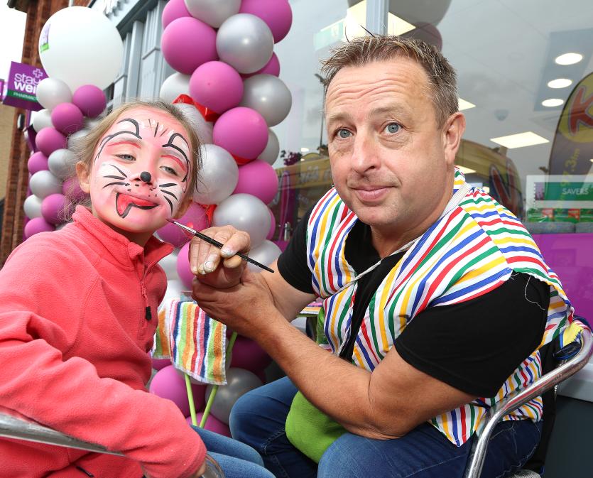 Mary Lowry gets her face painted by Mikey Bubbles from Funtime Entertainment