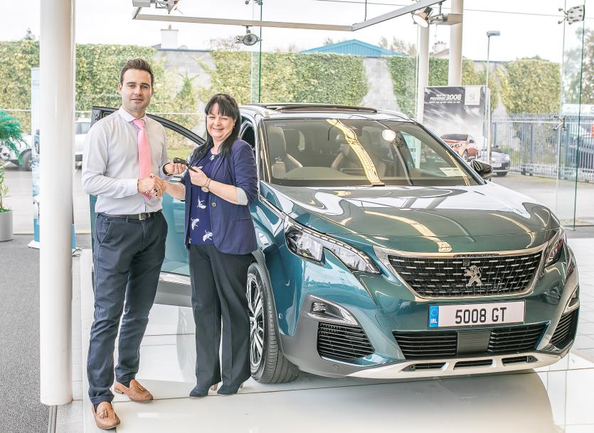 Nicholas Mulhall of Conlans hands over a set of keys to a delightful customer