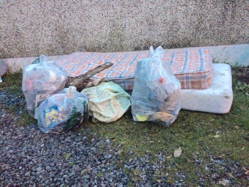 Mattress and household rubbish dumped outside Christmas Tree recycling