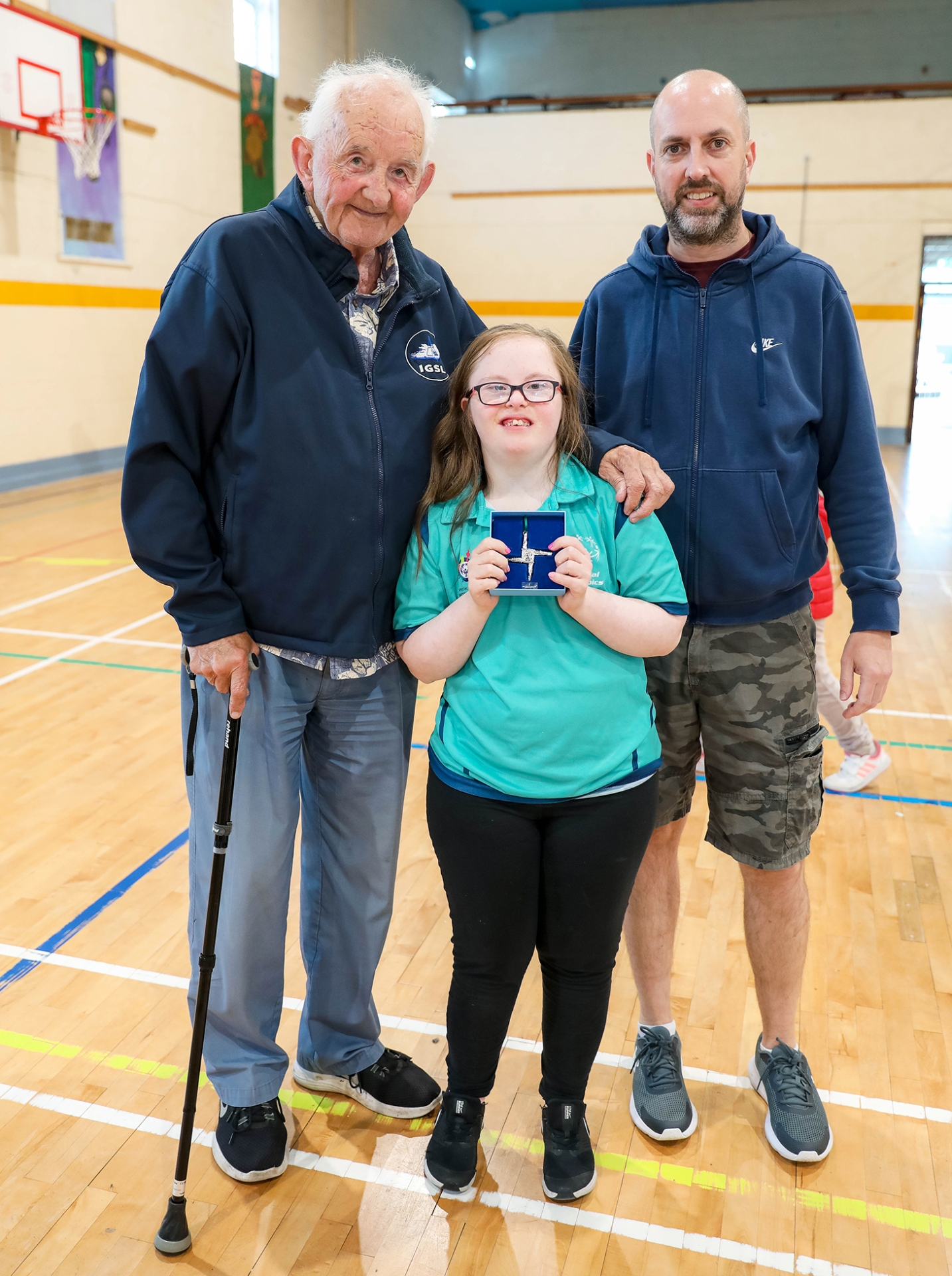 Joe Clancy and Paddy Slattery (Assistant Coach) present Grace Kavanagh with a St Brigids Cross