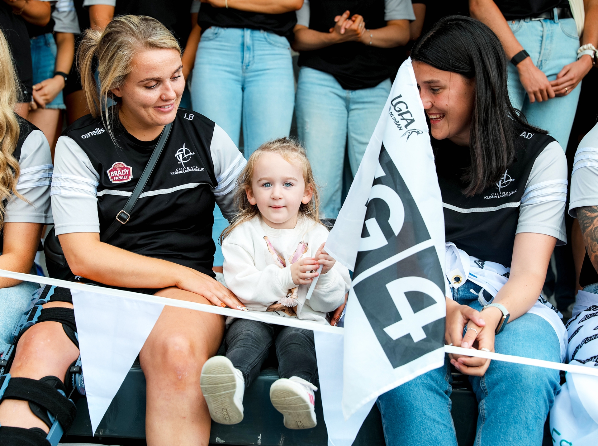 Kildare's no.1 fan Faye Dungan with Kildare Players Anna Dunlea and Lauren Burke